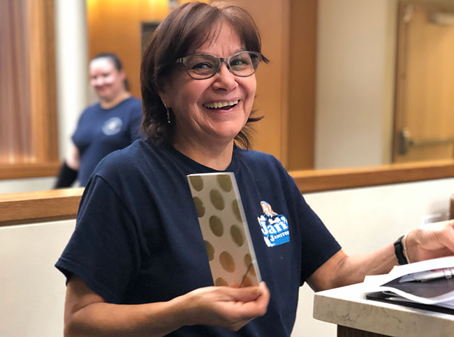 Woman laughs as she accepts gifts