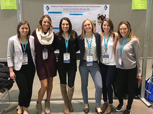 Six women standing together at conference