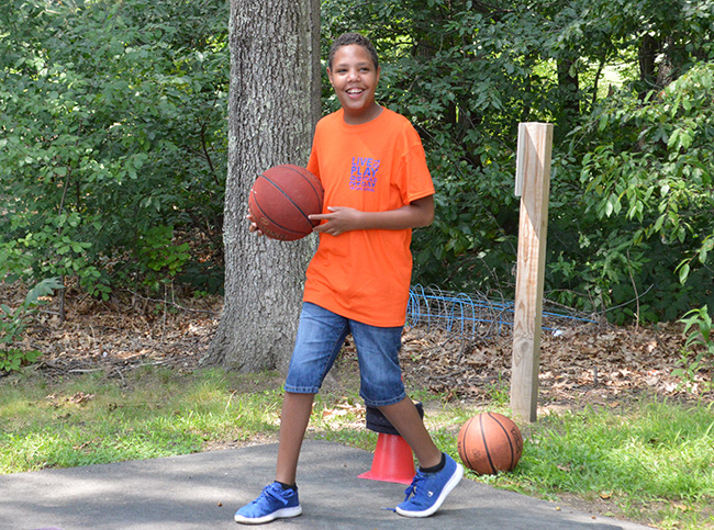 Student playing basketball on Field Day