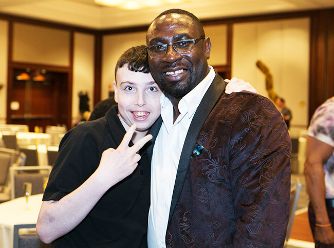 Student and staff member smiling