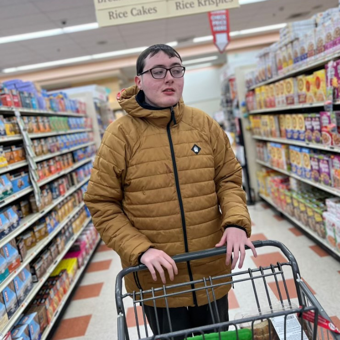 Guild School student in the aisle of a grocery store