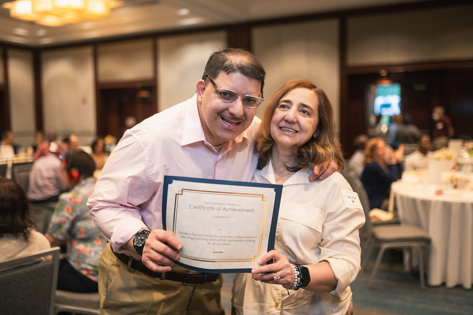A Guild resident poses with his mom and his award