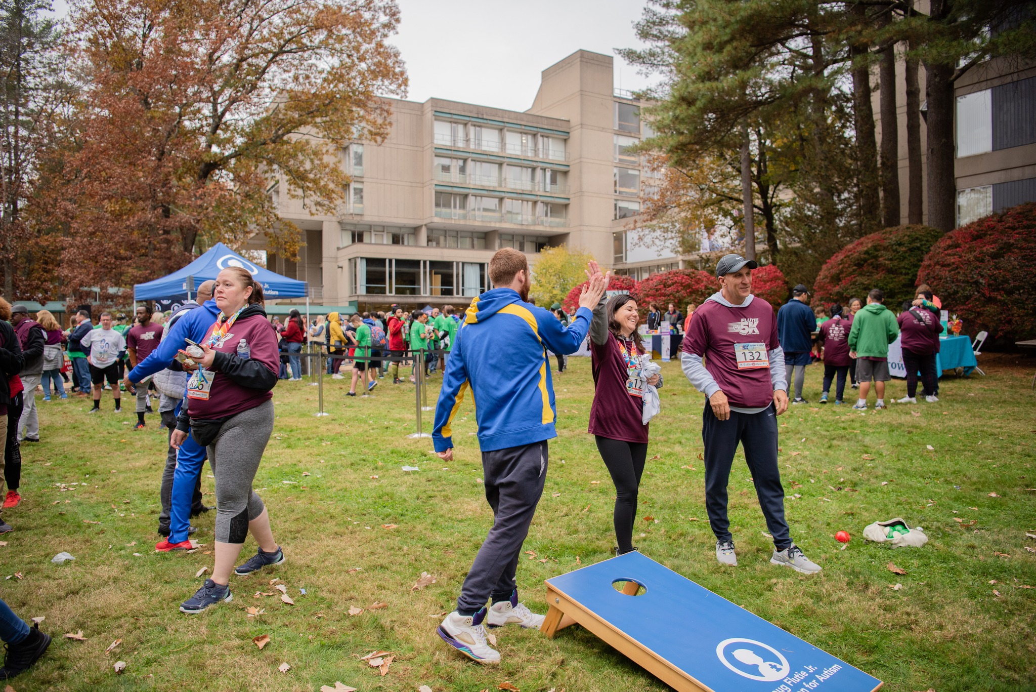 Members of Team Guild play lawn games at the Flutie 5k