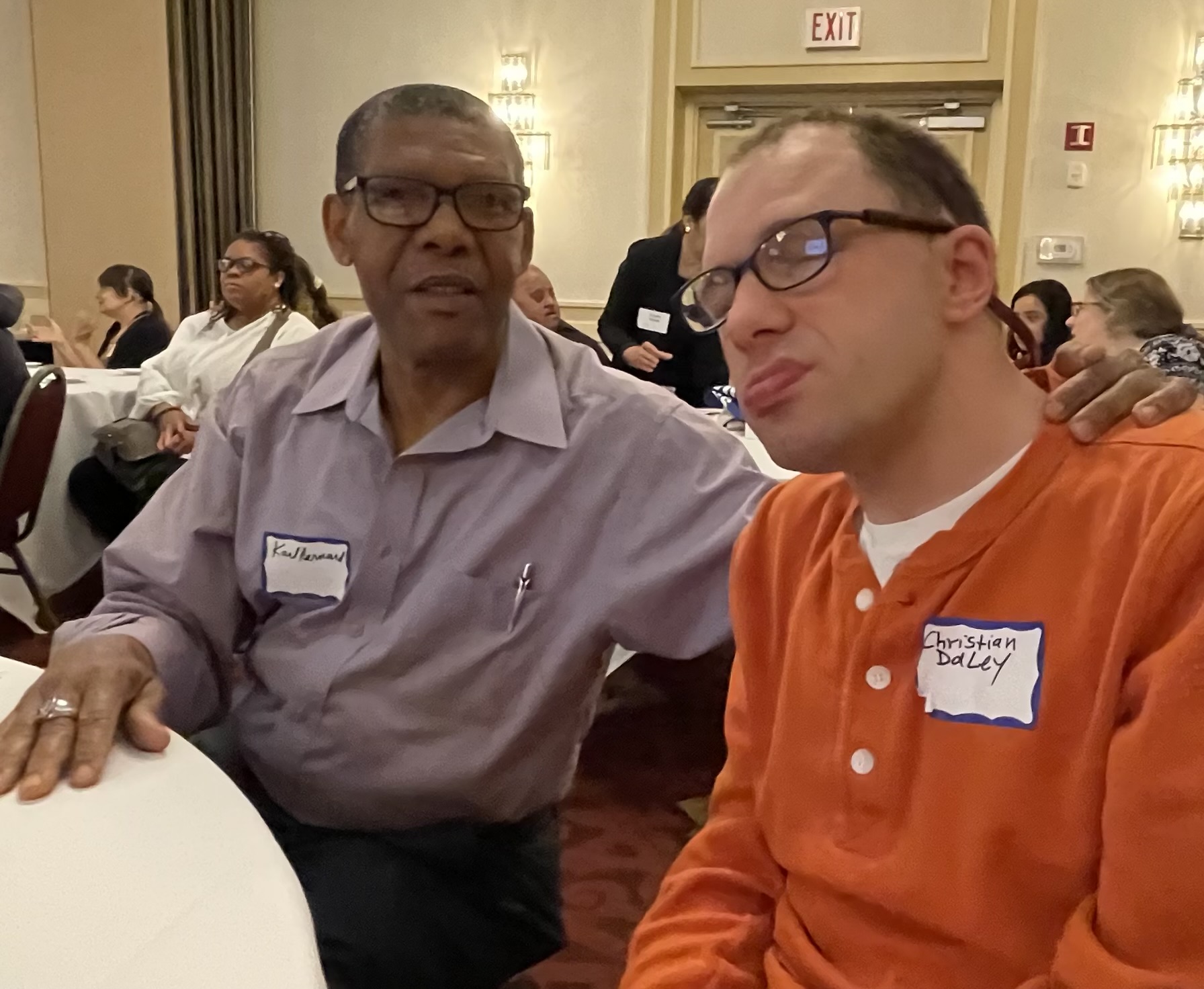 Christian with a Guild staff member at a self-advocacy conference