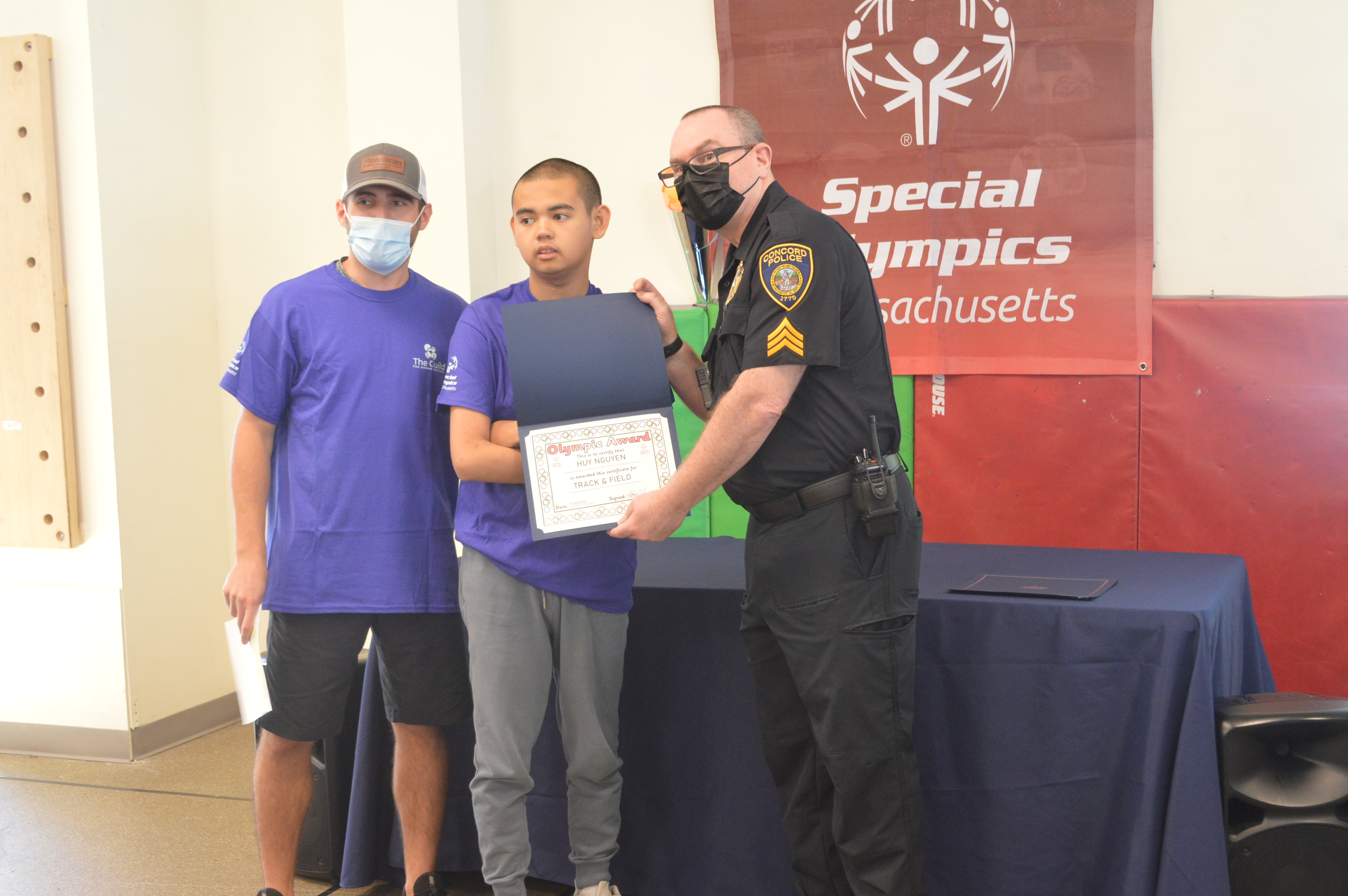 Thomas Lucia, Guild for Human Services with Guild School student Huy Nguyen and Concord Police Sergeant Tim Landers