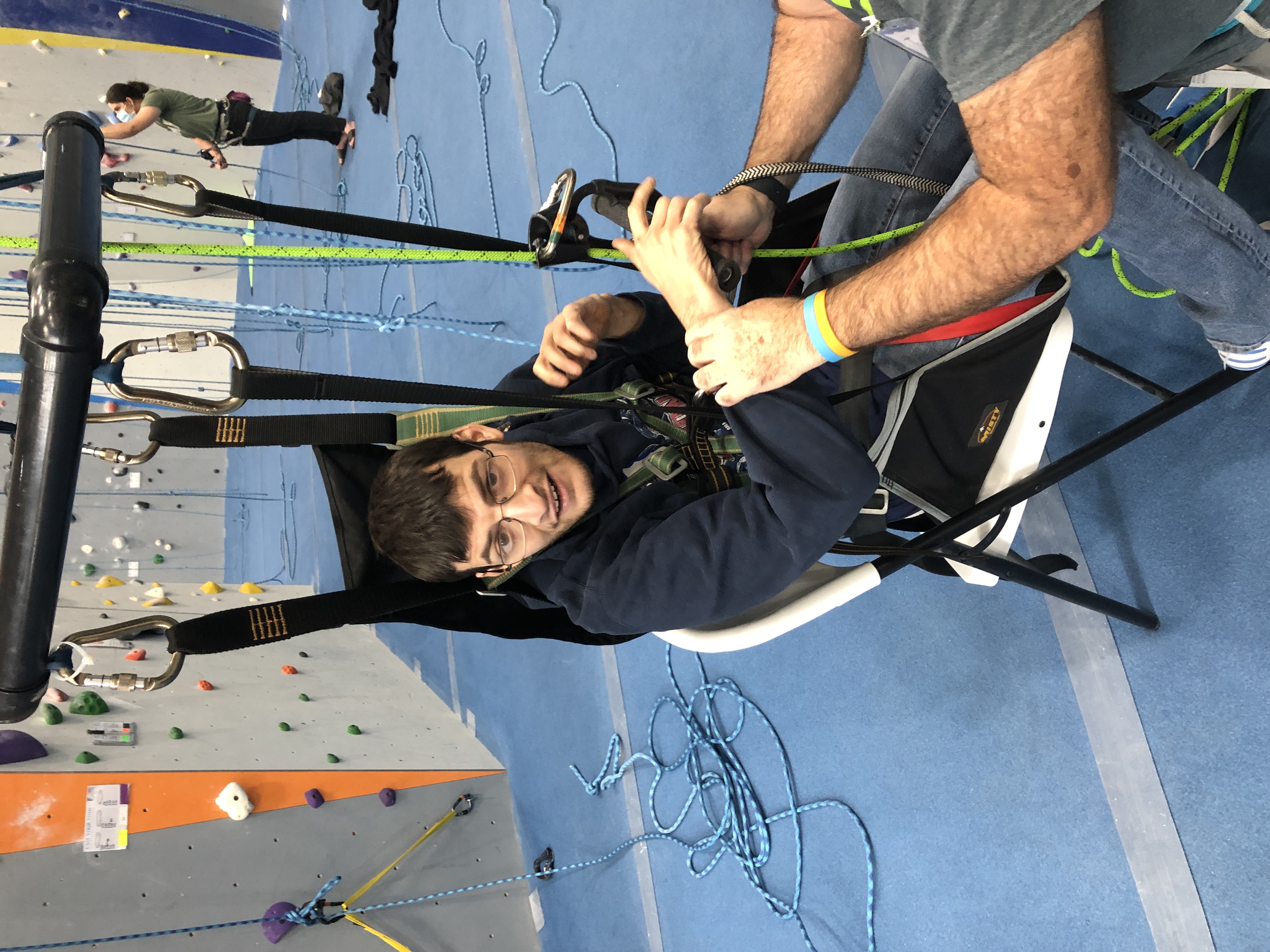 Aaron, adult resident with The Guild, gears up to go indoor rock climbing with Waypoint