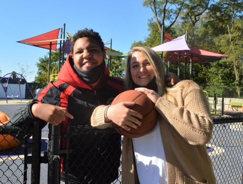 Guild staff member and student on playground