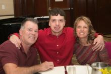 Kyle S. with his parents