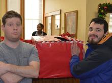 Two students in front of gift box